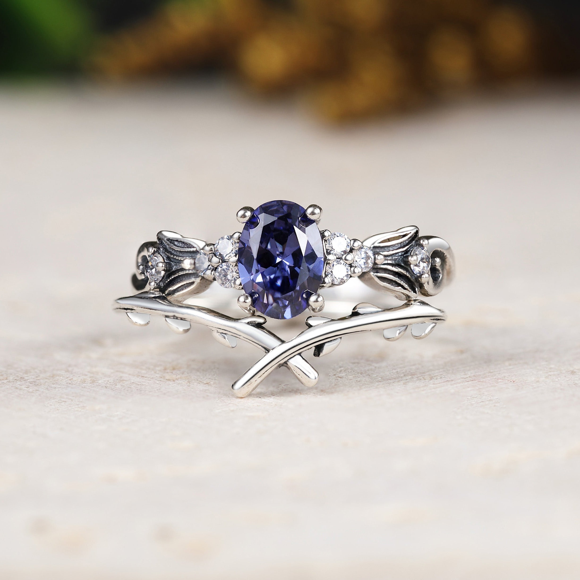 Silver ring with a blue gemstone on a light surface