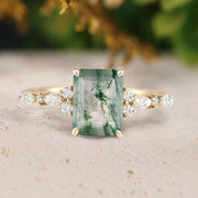 Ring with a green gemstone and gold accents on a neutral background