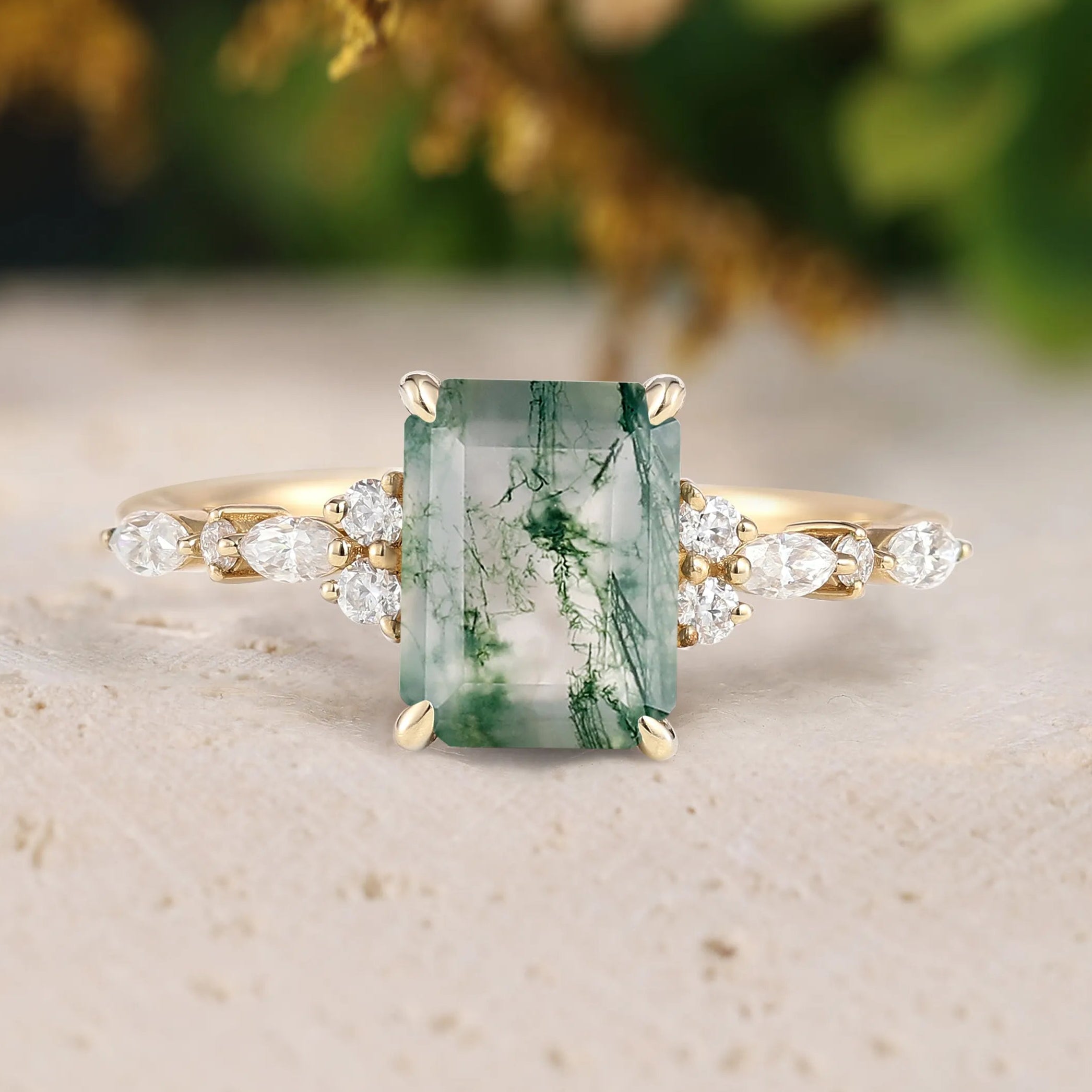 Ring with a green gemstone and gold accents on a neutral background