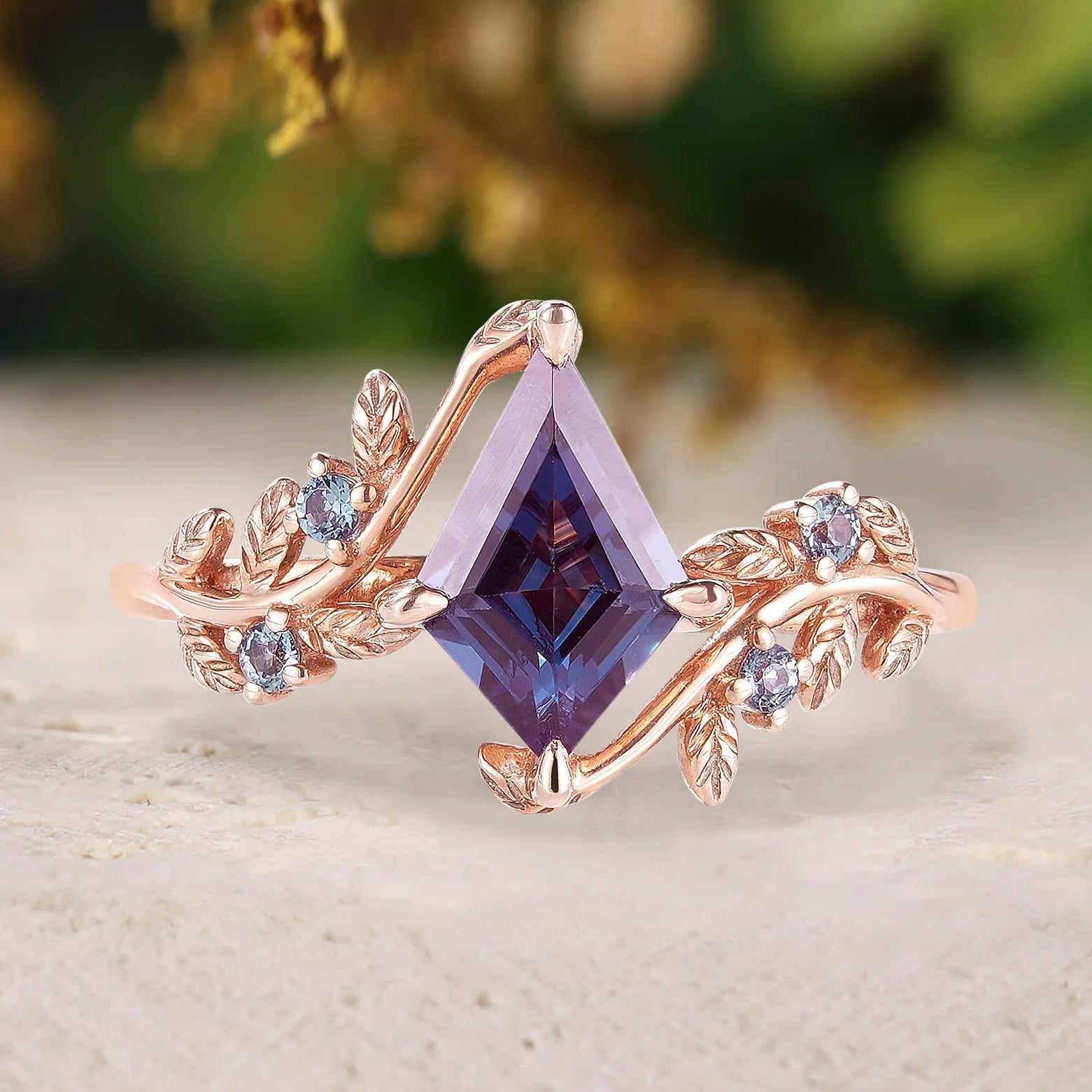 Rose gold ring with purple gemstone and small diamonds on a natural background