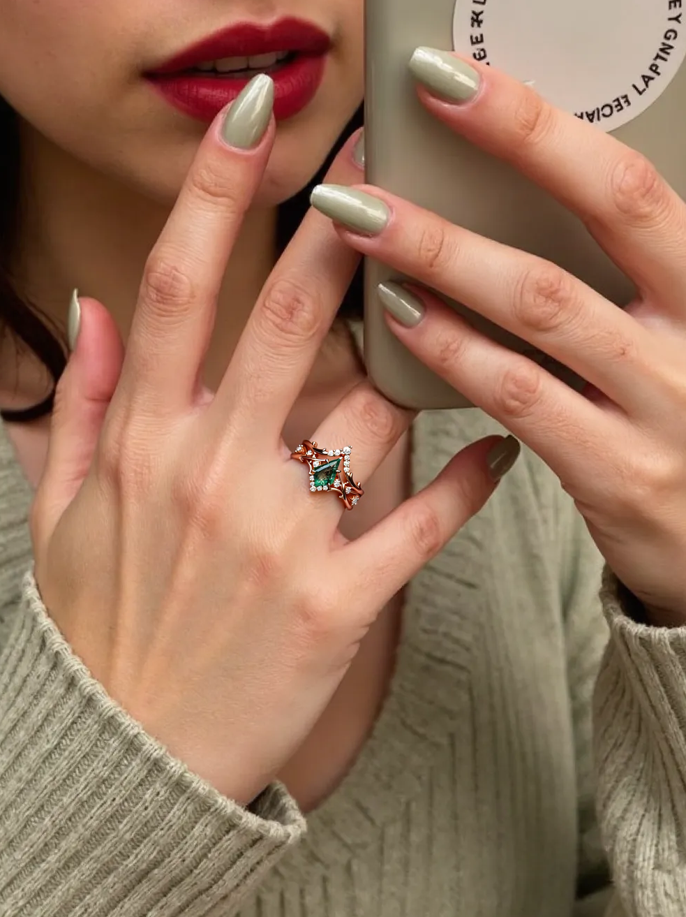 Person holding a phone with a visible ring on their finger