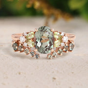 Rose gold ring with green gemstone on a beige surface