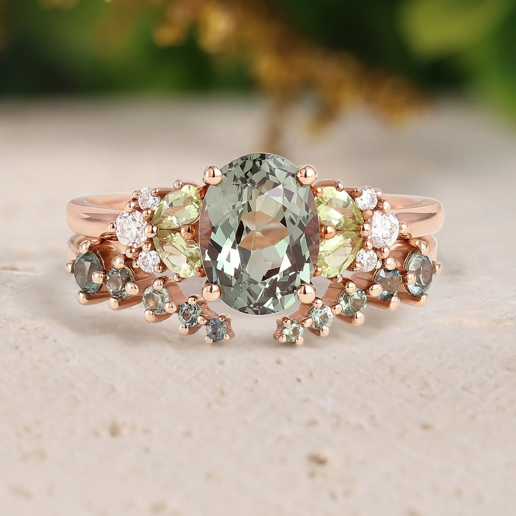 Rose gold ring with green gemstone on a beige surface