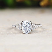 Diamond ring on a light wooden surface with a blurred natural background