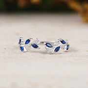 Pair of silver earrings with blue gemstones on a light surface.
