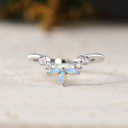 Silver ring with gemstones on a light background