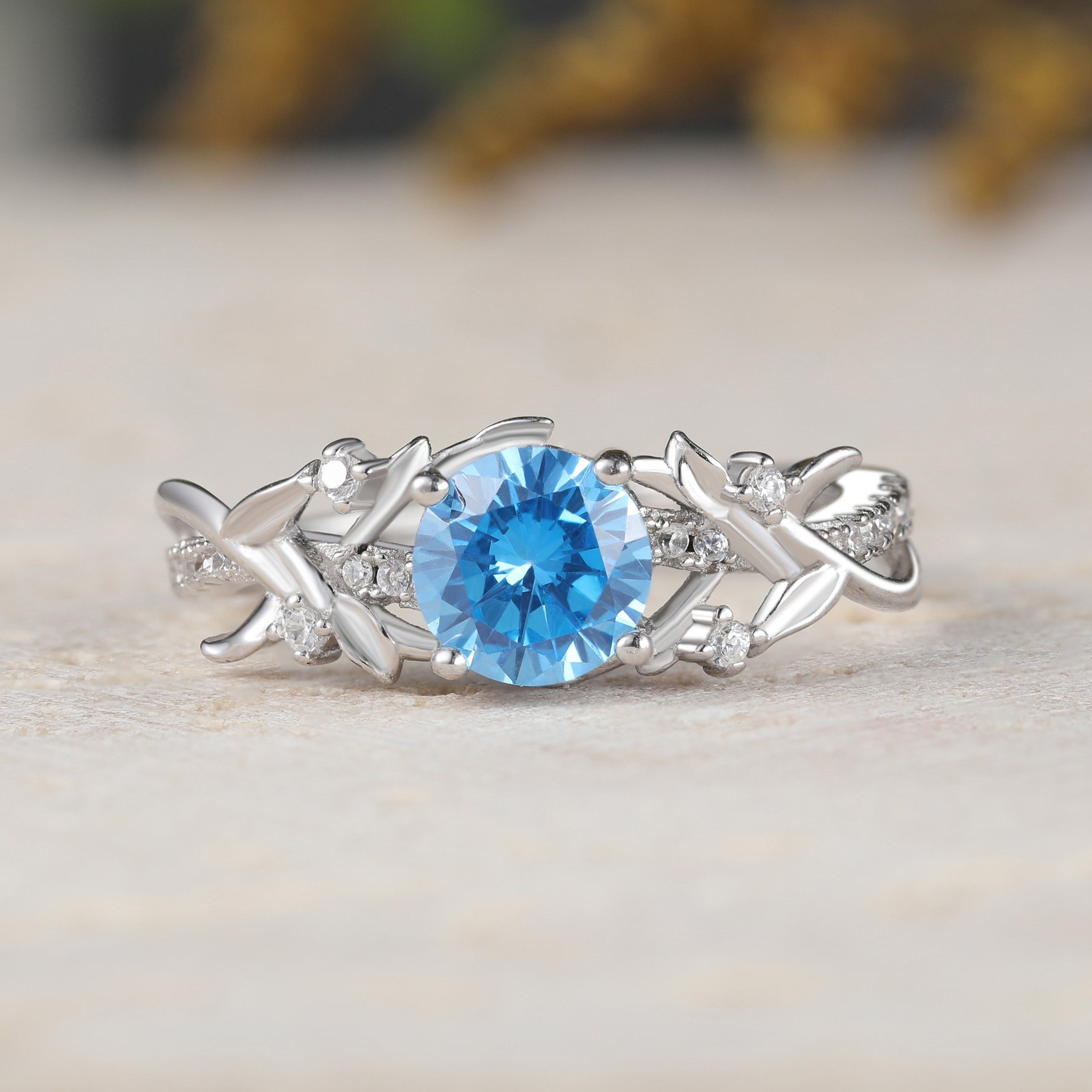 Silver ring with a blue gemstone on a neutral background