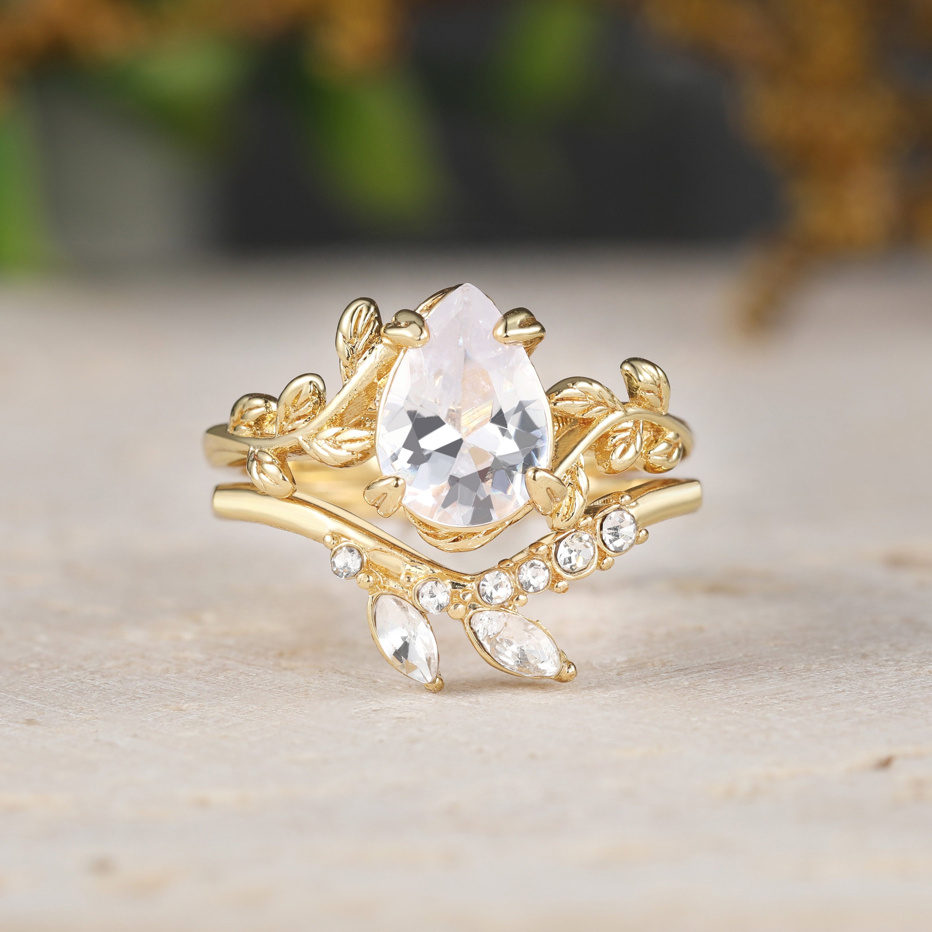 Gold ring with a clear gemstone on a wooden surface