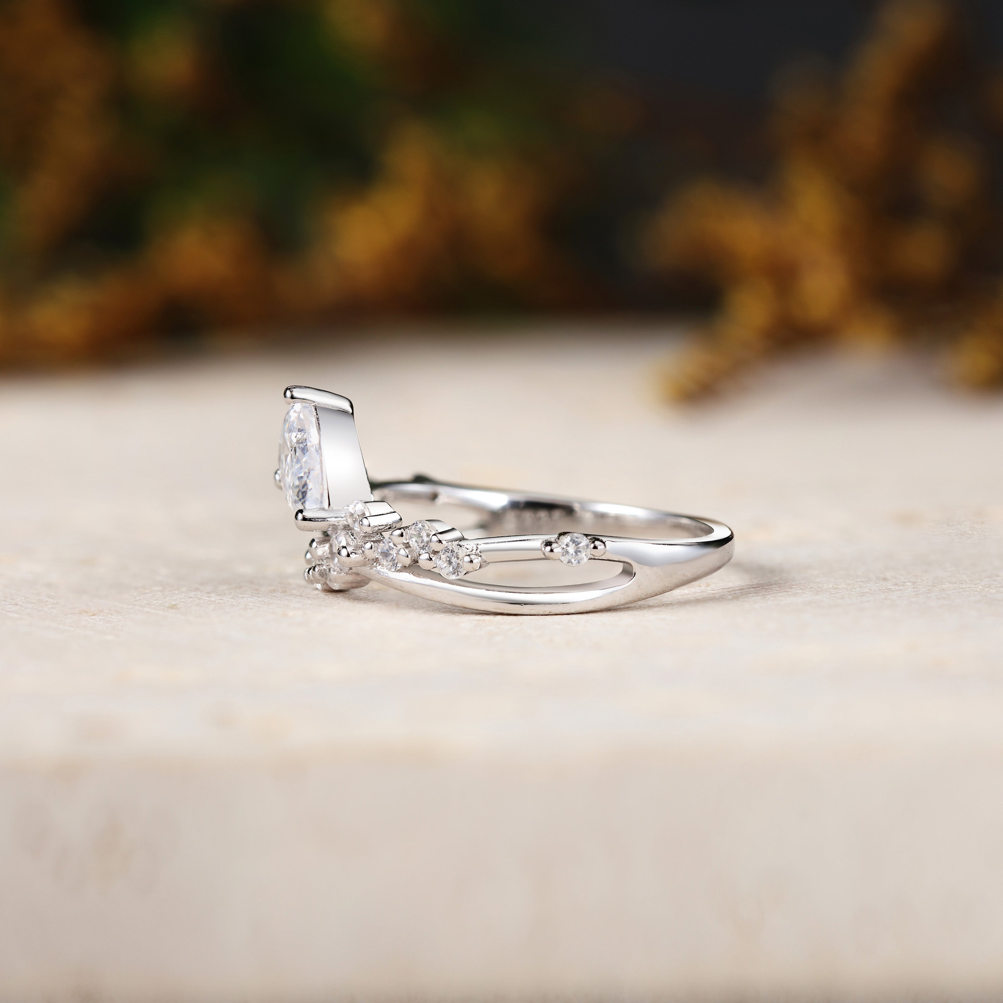 Tilted Pear Moissanite Ring with Twisted Pavé Band