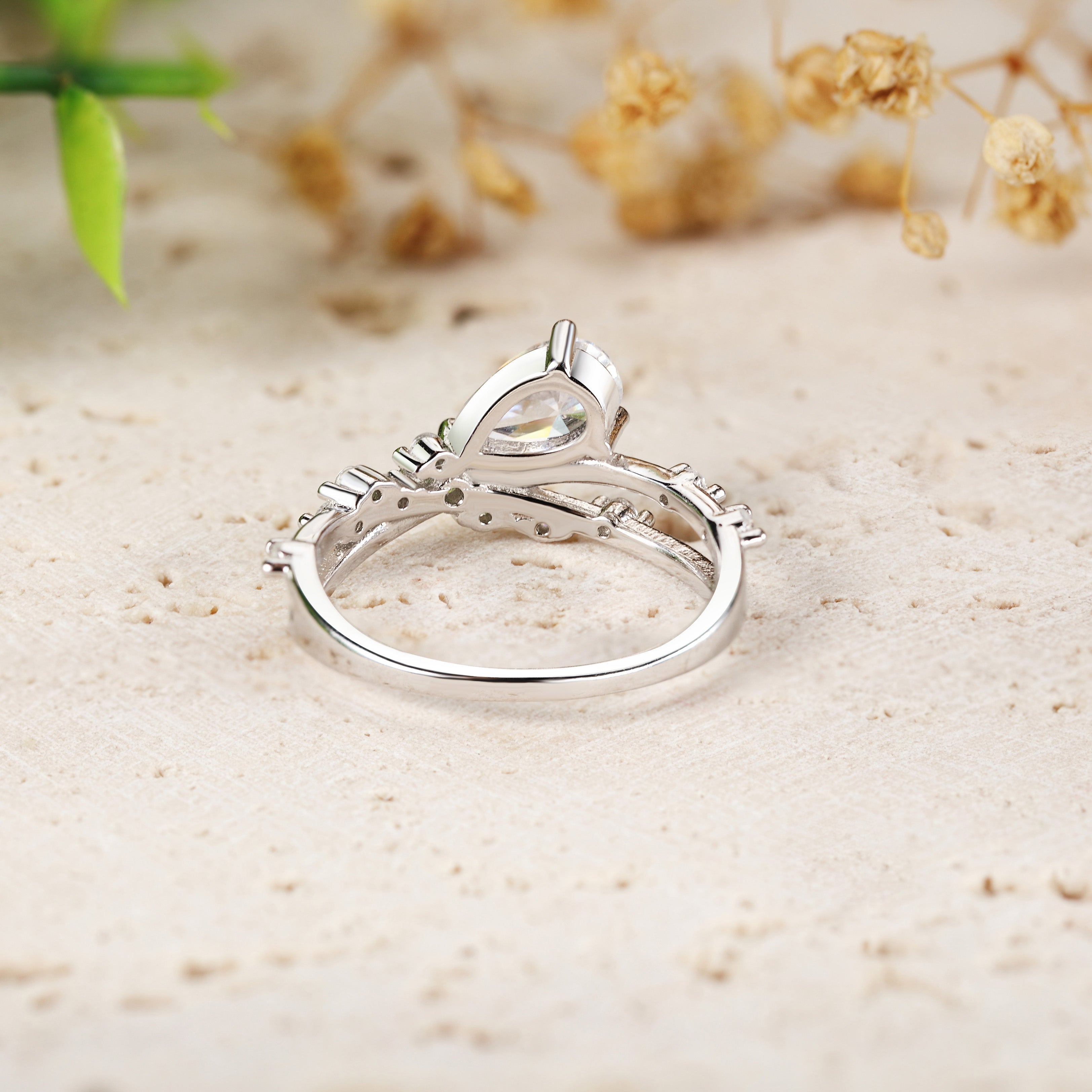 Tilted Pear Moissanite Ring with Twisted Pavé Band