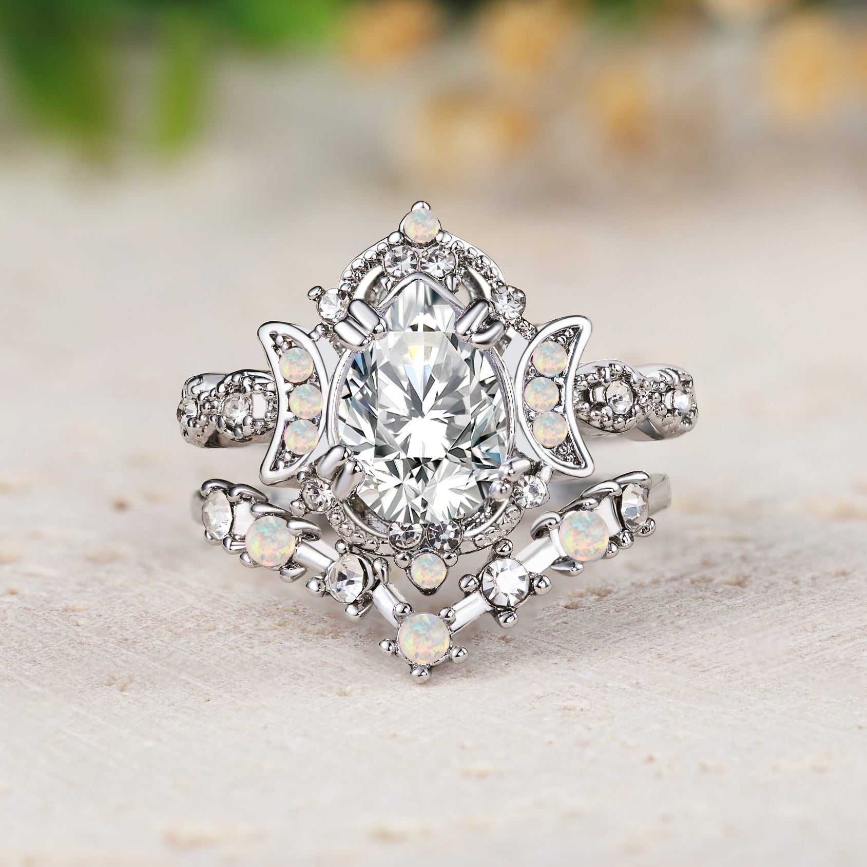 Silver ring with a large central gemstone on a light surface