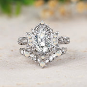 Silver ring with a large central gemstone on a light surface