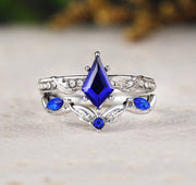 Silver ring with blue gemstones on a light background