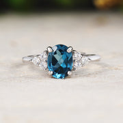 Silver ring with a blue gemstone on a light surface