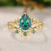 Gold ring with a green gemstone on a textured surface