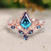 Rose gold ring with blue gemstone on a neutral background