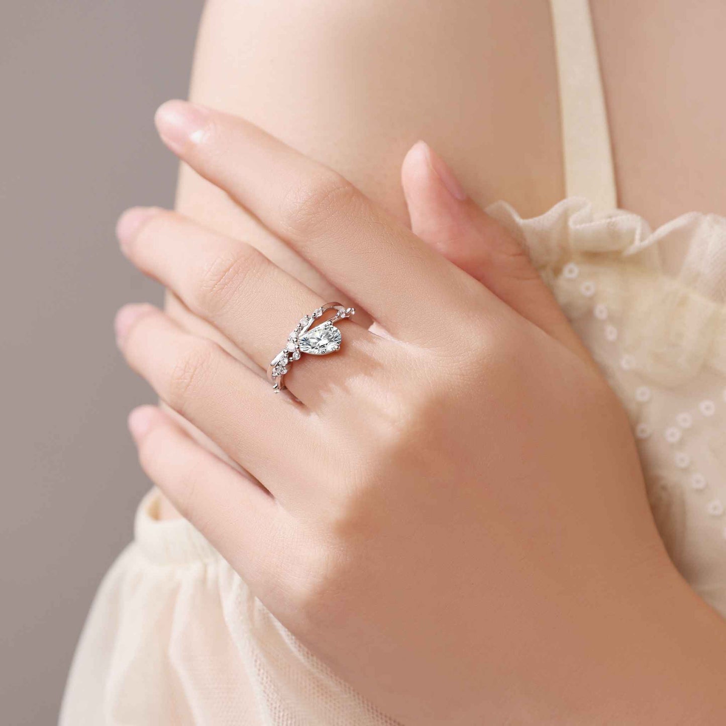 Tilted Pear Moissanite Ring with Twisted Pavé Band