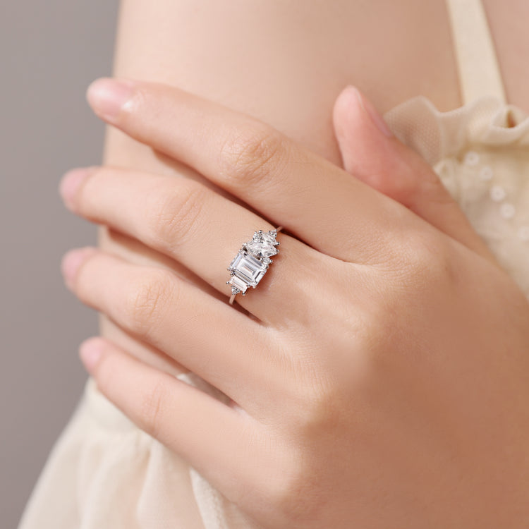 Close-up of a hand wearing a diamond ring with a soft background