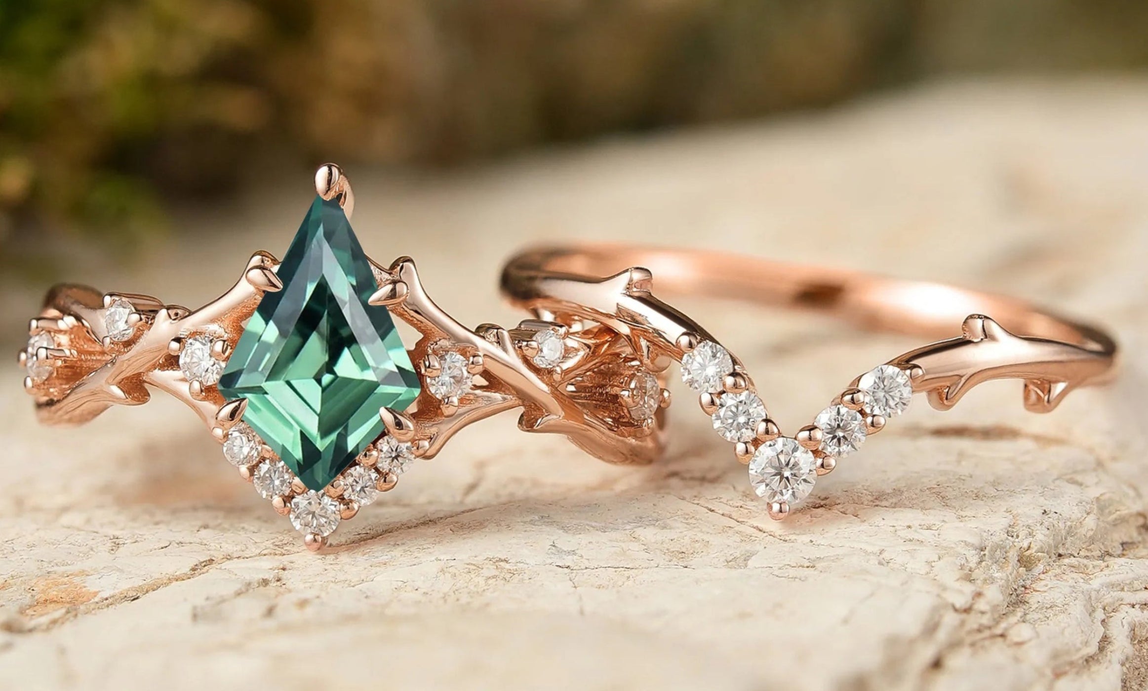 Rose gold ring with green gemstone on a wooden surface