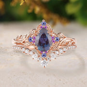 Rose gold ring with purple gemstone and diamonds on a light background