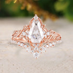 Rose gold ring with a large diamond on a textured surface
