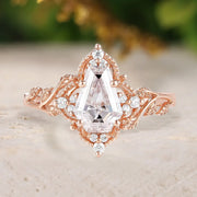 Rose gold ring with a large diamond on a light background