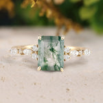 Ring with a green gemstone and gold accents on a neutral background