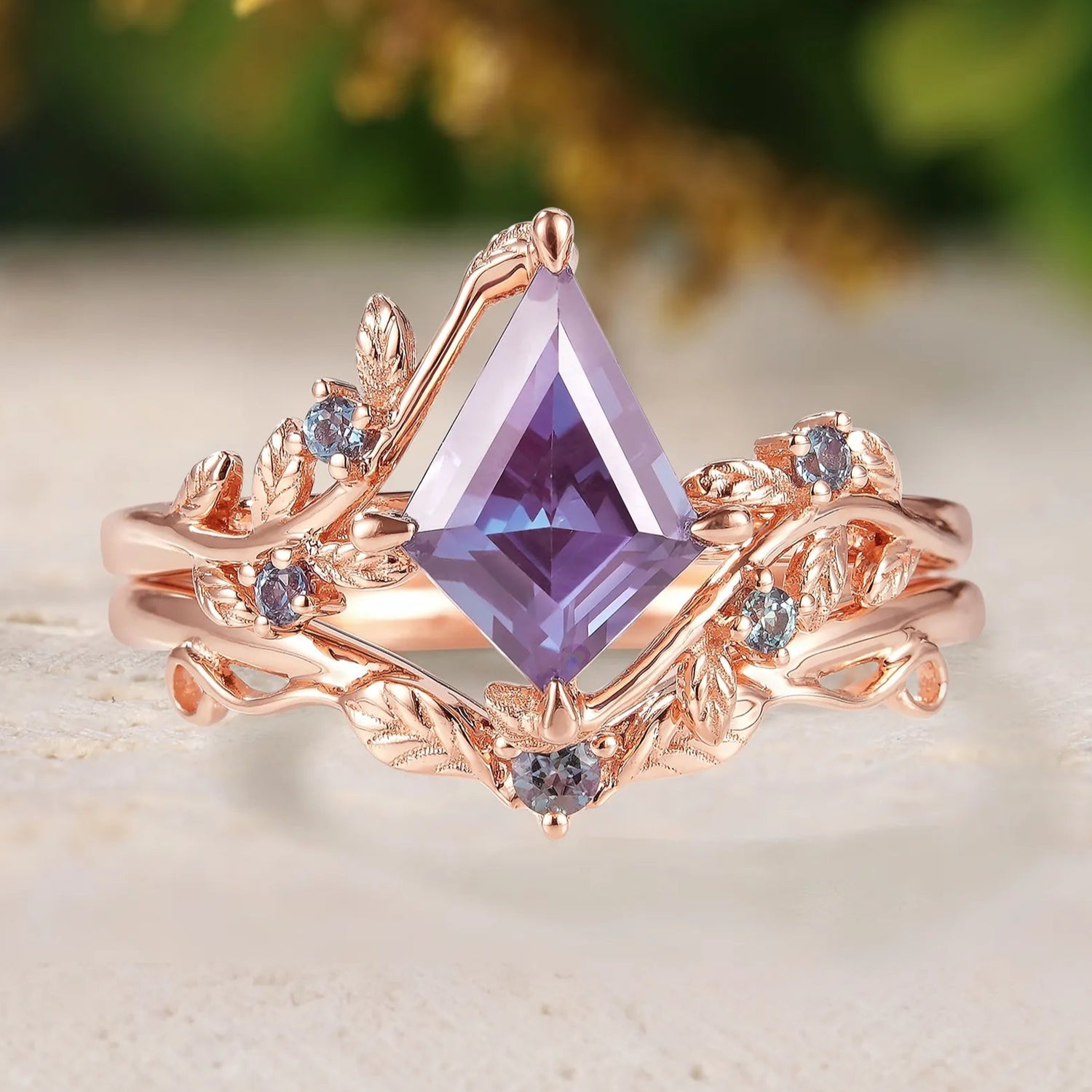 Rose gold ring with a purple gemstone on a light background