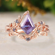 Rose gold ring with a purple gemstone on a light background